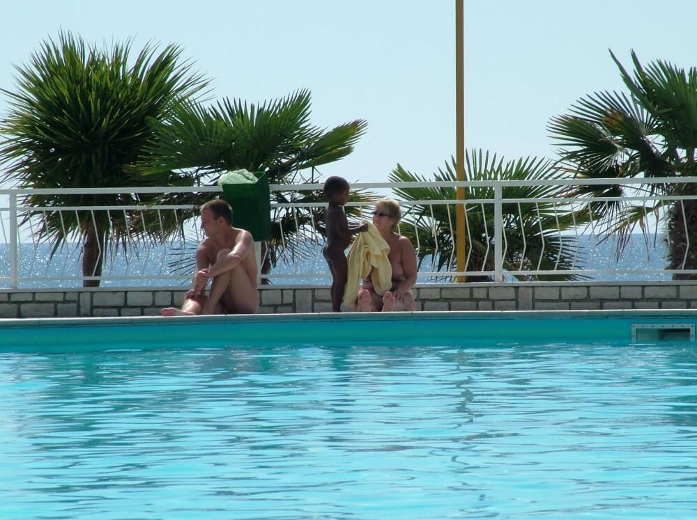 Photo of naturists in an outdoor pool - A resort for nature lovers